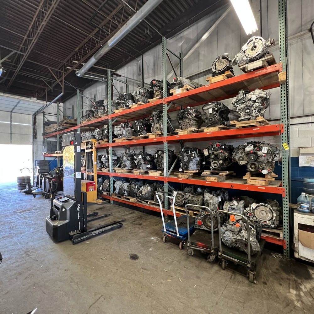 Organized shelves of used engines and transmissions for Second Life Auto Parts customers